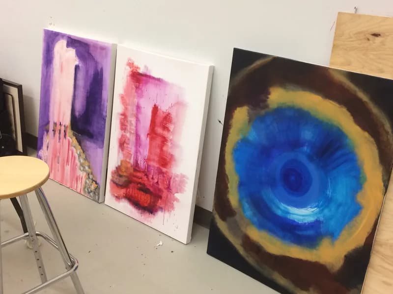Canvases drying against the studio wall.