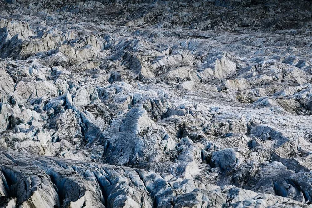 Frozen Symphony: The Majestic Dance of Glaciers and Rocky Textures in Blue Hues