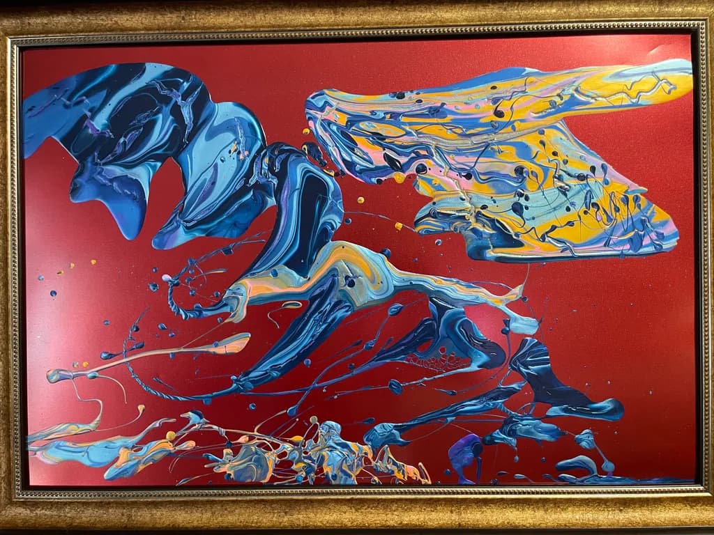 Vibrant Fluidity: A Dynamic Dance of Color on Red Canvas